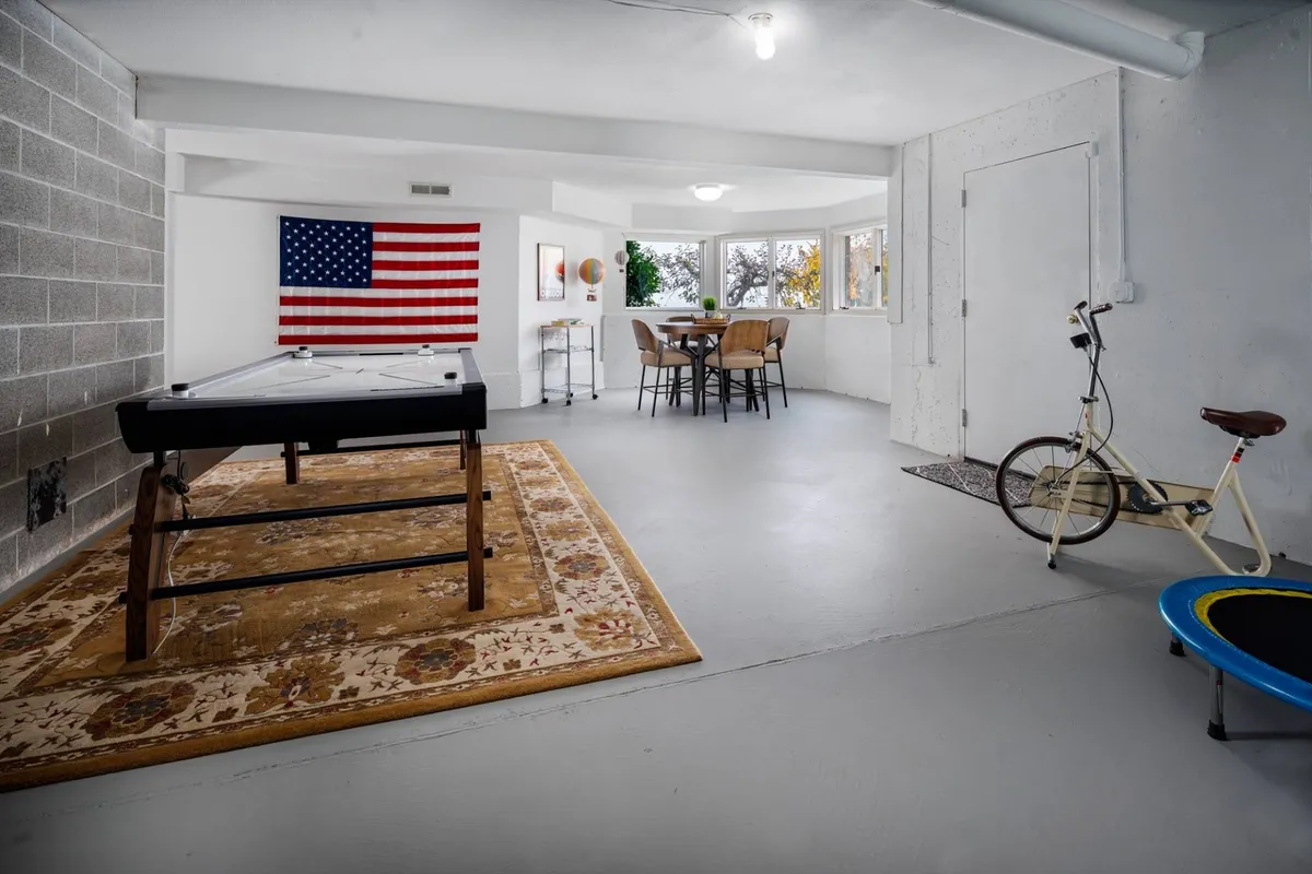Inside the villa, this vibrant scene showcases a pool table, dining area, and fun decorative elements like a globe and bicycle. The space is designed for play, socializing, and family interaction, reflecting the energetic, playful spirit described in the section.